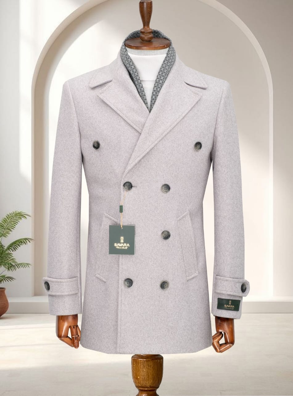 A men's cream double-breasted formal overcoat displayed on a wooden mannequin with a patterned scarf detail.
