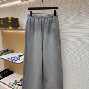 Front view of Acne Studios Grey Melange Sweatpants featuring a wide-leg silhouette and tonal 96 graphic on a display hanger.