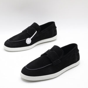 Black suede slip-on loafer sneakers with an H-shaped vamp strap and white rubber soles on a white background.