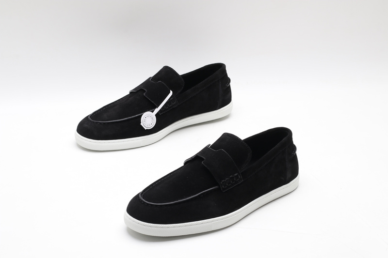 Black suede slip-on loafer sneakers with an H-shaped vamp strap and white rubber soles on a white background.
