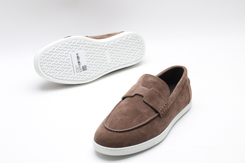 Taupe suede slip-on loafer sneakers with an H-shaped vamp strap and white rubber soles on a white background.