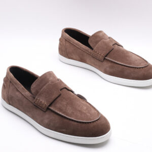 Taupe suede slip-on loafer sneakers with an H-shaped vamp strap and white rubber soles on a white background.