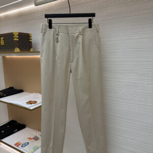 Front and back view of the premium Prada Logo Charm Beige Chino Trousers hanging on display, showcasing the tailored leg crease and rear buttoned pockets.