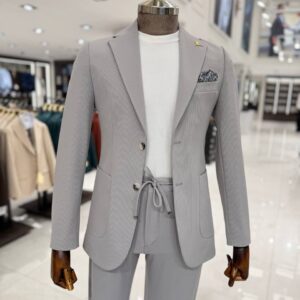 Men wearing a lightweight tailored grey smart casual suit with a white crew-neck T-shirt, styled for summer business casual and wedding occasions.